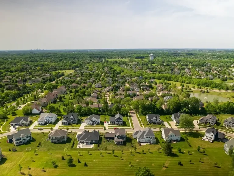 Aerial view of a suburban neighborhood with houses and trees.