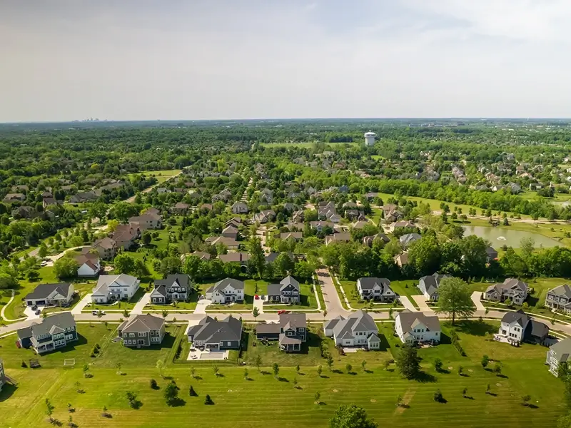 Aerial view of a suburban neighborhood with houses and trees.
